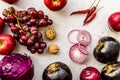 Raw purple vegetables and fruit on white wooden background top view