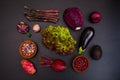 Raw purple vegetables over gray black background. Royalty Free Stock Photo