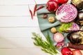 Raw purple vegetables and fruit on white wooden background with copy space top view