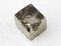 raw pyrite crystal on white marble