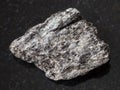 raw quartz-biotite schist stone on dark