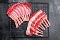 Raw rack of lamb, fresh mutton meat for chops cutlets. black background. top view Royalty Free Stock Photo