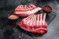 Raw rack of lamb, fresh mutton meat for chops cutlets. black background. top view Royalty Free Stock Photo