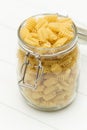 Raw radiatori pasta on a glass jar Royalty Free Stock Photo