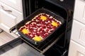 Raw raspberries and apricots pie on a baking sheet in the oven Royalty Free Stock Photo