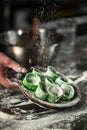 Raw ravioli filled with ricotta cheese and spinach. home cooking concept. vertical image. top view. place for text Royalty Free Stock Photo