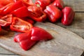 Raw red bell pepper sliced into halves on a wooden background