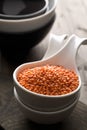 Raw red, dried lentils in bowl on table Royalty Free Stock Photo