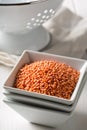 Raw red, dried lentils in bowl on table Royalty Free Stock Photo