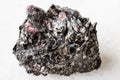 Raw red Garnet crystals in Biotite rock on white