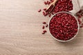 Raw red kidney beans with bowl, scoop and bag on wooden table, flat lay. Space for text Royalty Free Stock Photo