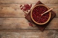 Raw red kidney beans with bowl, spoon and napkin on wooden table, flat lay. Space for text Royalty Free Stock Photo