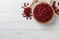 Raw red kidney beans with bowl and spoon on white wooden table, flat lay. Space for text Royalty Free Stock Photo