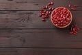 Raw red kidney beans with bowl on wooden table, flat lay. Space for text Royalty Free Stock Photo