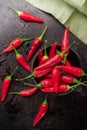 Raw red mexican chili peppers on a black rusty table