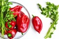 Raw red organic peppers with bunch of aromatic green spice parsley in a glass bowl Royalty Free Stock Photo