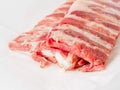 Raw pork ribs on white parchment paper, side view Royalty Free Stock Photo