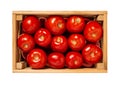 Raw red tomatoes in a wooden crate isolated on a white background. Fresh ripe tomatoes in a wooden box cutout. Vegetables for Royalty Free Stock Photo