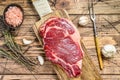 Raw rib eye steak on the bone. Marble beef meat ribeye. wooden background. Top view