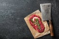 Raw ribeye steak and butcher knife on blackboard Royalty Free Stock Photo