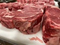 Raw Ribeye steak cuts on a butcher table side view Royalty Free Stock Photo