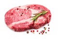 Raw ribeye steak with pepper corns and rosemary isolated on white background