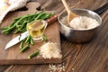 Raw rice with oil and green beans on wooden board Royalty Free Stock Photo