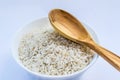 Raw rice in white plate and wooden spoon Royalty Free Stock Photo