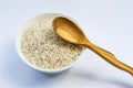 Raw rice in white plate and wooden spoon Royalty Free Stock Photo