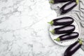 Raw ripe eggplants on marble background Royalty Free Stock Photo