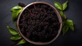 Raw ripe elderberry in a bowl standing on a dark table, top down view. generative ai