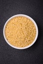 Raw risoni pasta made from durum wheat on a dark concrete background Royalty Free Stock Photo