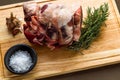 Raw rolled and tied Herdwick Sheep lamb joint with garlic, rosemary and sea salt Royalty Free Stock Photo