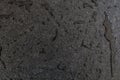 Raw and rough black granite slab wet with water. Drops and patch