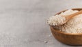 Raw round white rice in a wooden bowl and in a wooden spoon. Copy space Royalty Free Stock Photo