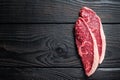 Raw rump steak or top sirloin cap beef meat steaks on butcher table. Black wooden background. Top view. Copy space Royalty Free Stock Photo