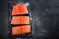 Raw salmon filet on dark slate background, wild atlantic fish, space for text Royalty Free Stock Photo