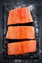 Raw salmon filet on dark slate background, wild atlantic fish