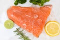 Raw salmon filet with herbs and spices on white background, Fresh salmon fish on ice Royalty Free Stock Photo