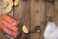 Raw salmon fillet with pepper sweetbread and salt on baking paper rustic theme with copy-space. Flat lay Royalty Free Stock Photo