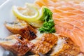 Raw salmon fillet pieces served with lemon, black olives and herbs on white plate close up with selective focus Royalty Free Stock Photo