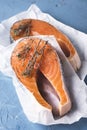 Raw Salmon Fish Steak with Dried Thyme Herbs Blue Background Fresh Fish Top View Copy Space Vertical Royalty Free Stock Photo