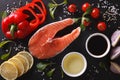 Raw salmon and ingredients on a black board close-up. horizontal Royalty Free Stock Photo