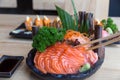 Raw salmon sashimi on black plate - Japanese food Royalty Free Stock Photo