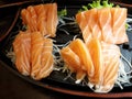 Raw salmon sashimi on black plate. It is japanese food Royalty Free Stock Photo