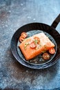 Raw salmon steak in a skillet or pan