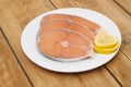 Raw salmon steak on white dish Royalty Free Stock Photo