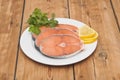 Raw salmon steak on white dish Royalty Free Stock Photo