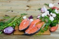Raw salmon steaks with fresh vegetables and mushrooms on wooden desk Royalty Free Stock Photo
