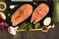 Raw salmon steaks over wooden background Royalty Free Stock Photo